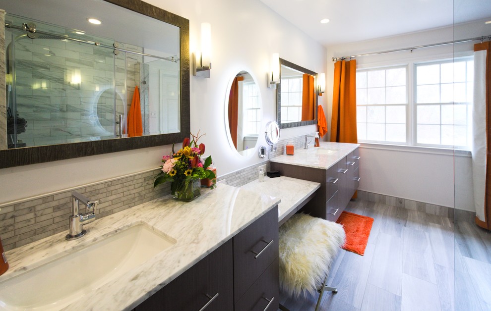 Photo of a small modern master bathroom in Philadelphia with flat-panel cabinets, grey cabinets, a corner shower, a two-piece toilet, gray tile, porcelain tile, white walls, porcelain floors, an undermount sink, engineered quartz benchtops, grey floor, a sliding shower screen and grey benchtops.