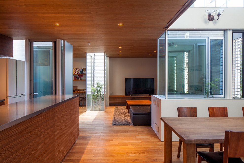 Inspiration for a midcentury open plan dining in Yokohama with white walls, medium hardwood floors and brown floor.