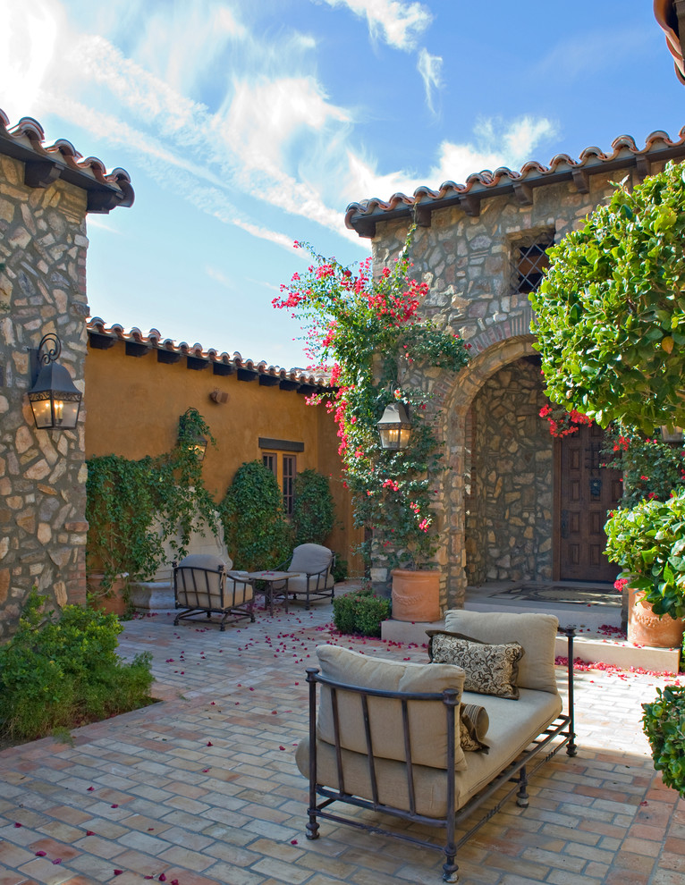 Design ideas for a mediterranean patio in Orange County with a water feature.