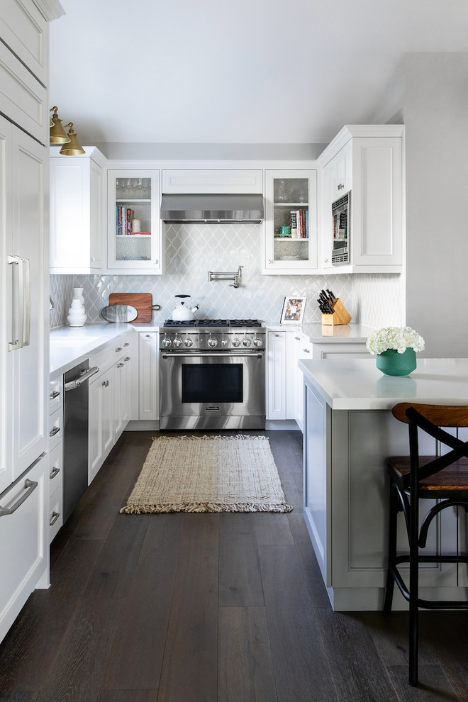 Design ideas for a mid-sized transitional u-shaped kitchen in San Diego with an undermount sink, white cabinets, quartz benchtops, grey splashback, ceramic splashback, with island, brown floor, white benchtop, recessed-panel cabinets, stainless steel appliances and dark hardwood floors.