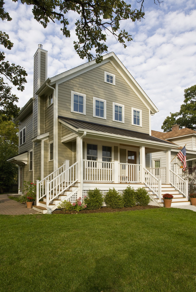 This is an example of a mid-sized traditional two-storey beige house exterior in Chicago with concrete fiberboard siding, a gable roof, a mixed roof, a black roof and clapboard siding.