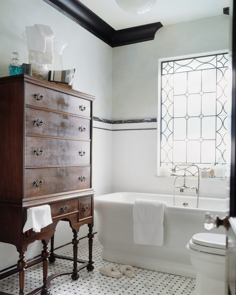 Photo of a traditional 3/4 bathroom in Other with a freestanding tub, white tile, subway tile, a shower/bathtub combo, a two-piece toilet, white walls, mosaic tile floors, multi-coloured floor and a shower curtain.