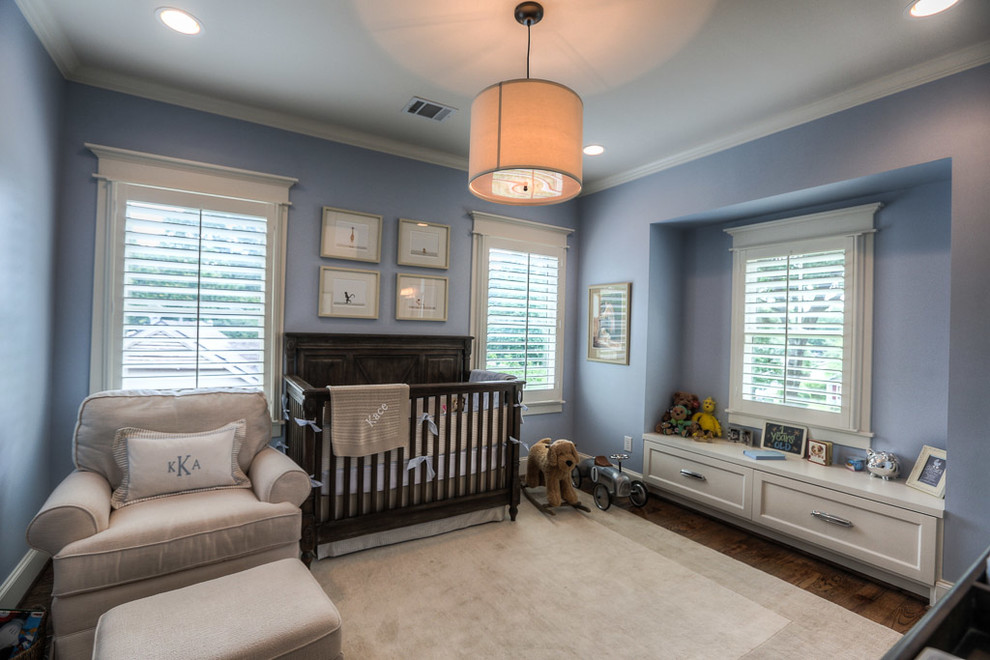 Inspiration for a mid-sized arts and crafts nursery for boys in Houston with blue walls and medium hardwood floors.