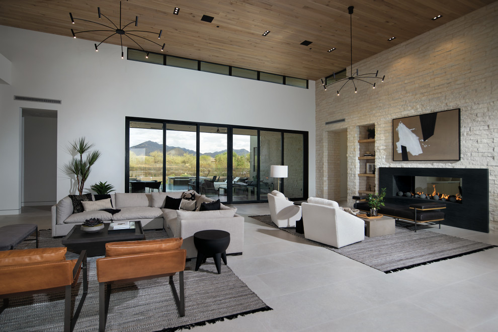 Inspiration for a huge contemporary formal and open concept beige floor living room remodel in Phoenix with white walls, a two-sided fireplace, a stone fireplace and a wall-mounted tv