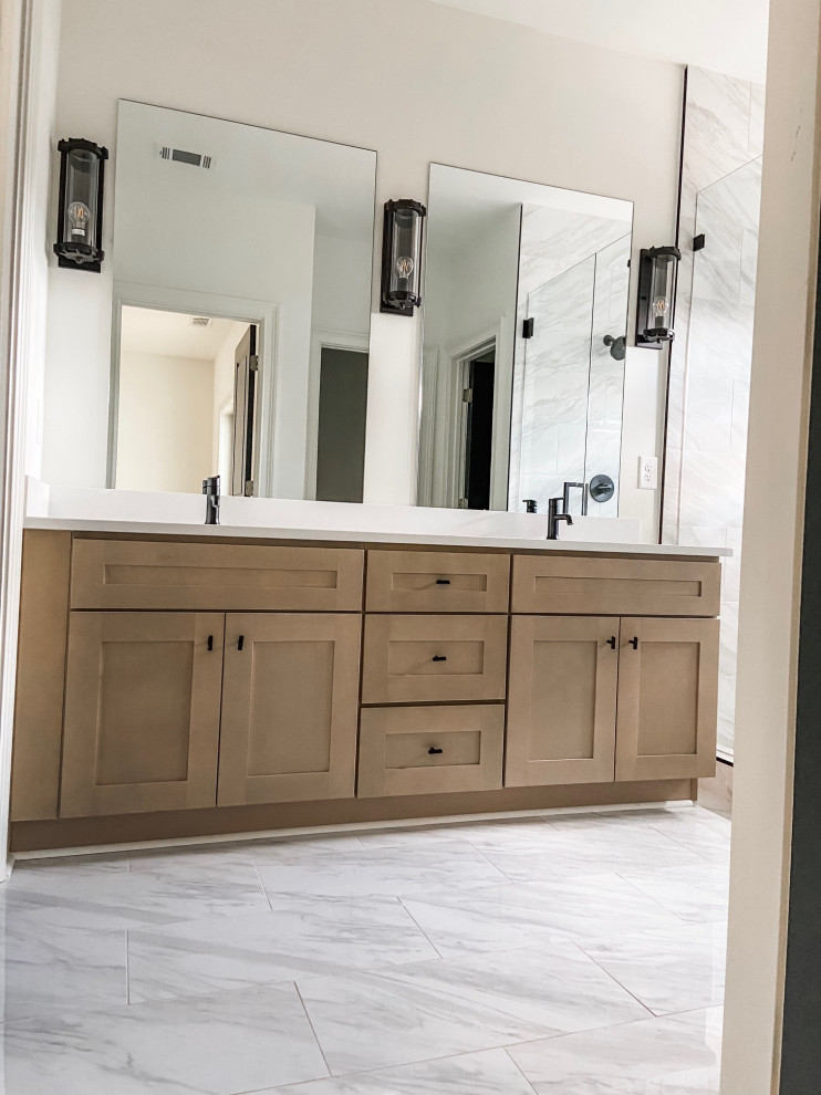 This is an example of a large transitional master bathroom in Atlanta with shaker cabinets, brown cabinets, a double shower, a one-piece toilet, white tile, marble, white walls, mosaic tile floors, a drop-in sink, engineered quartz benchtops, white floor, a hinged shower door, white benchtops, a double vanity, a built-in vanity and brick walls.