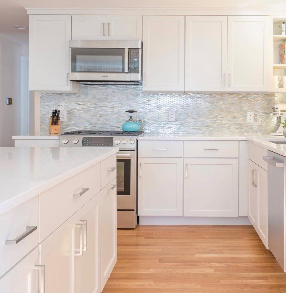 Mid-sized transitional l-shaped kitchen photo with beaded inset cabinets, white cabinets and an island
