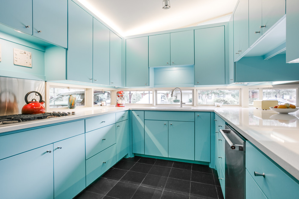 Photo of a mid-sized midcentury u-shaped separate kitchen in Dallas with an undermount sink, flat-panel cabinets, blue cabinets, quartz benchtops, window splashback, stainless steel appliances, slate floors and black floor.