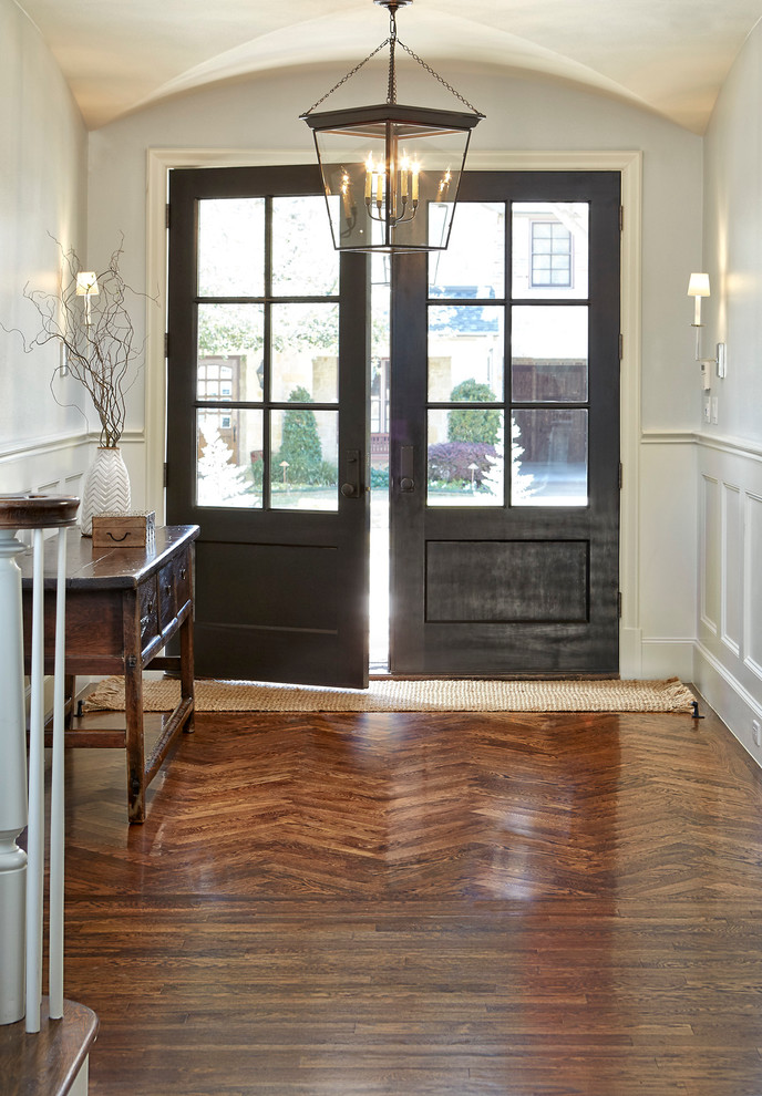 Photo of a large transitional foyer in Dallas with grey walls, a double front door, a black front door and medium hardwood floors.