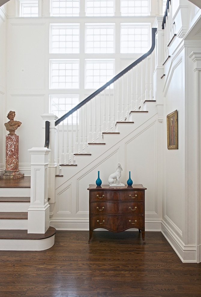 Traditional wood staircase in New York with wood railing.