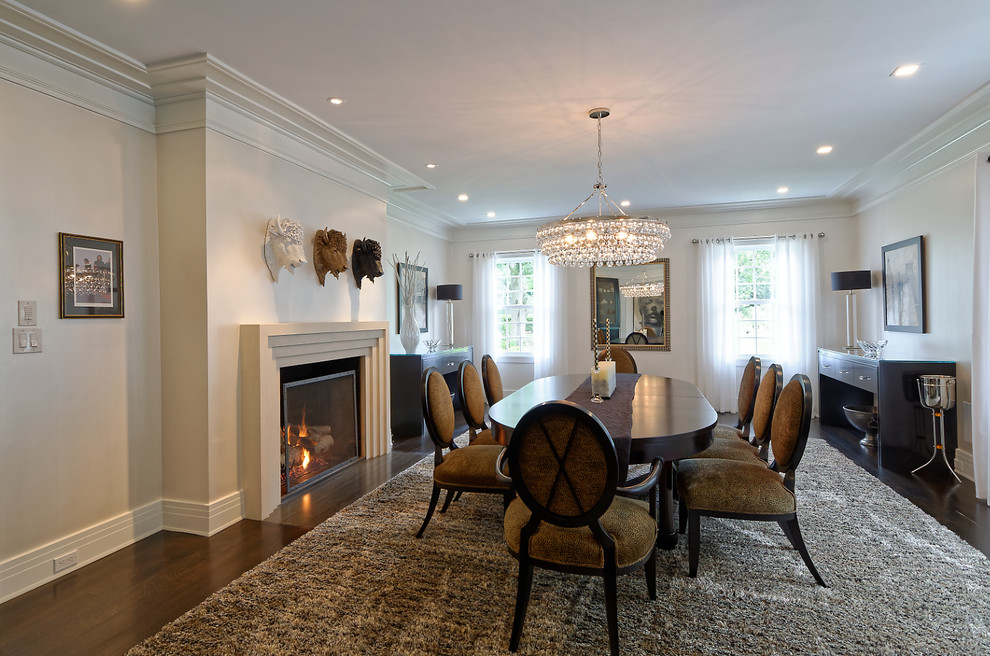 Large traditional separate dining room in New York with beige walls, dark hardwood floors, a standard fireplace, a concrete fireplace surround and brown floor.
