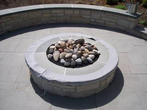 This is an example of a mid-sized traditional backyard patio in Chicago with a fire feature, no cover and tile.