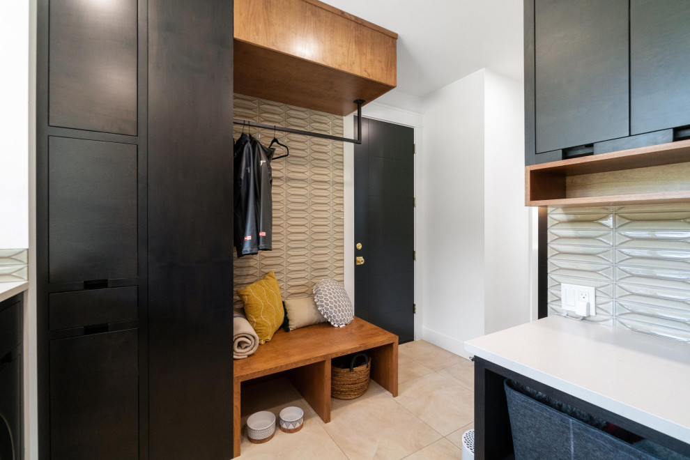 Design ideas for a mid-sized modern laundry room in Seattle with an undermount sink, flat-panel cabinets, dark wood cabinets, quartz benchtops, beige splashback, glass tile splashback, white walls, a side-by-side washer and dryer and white benchtop.