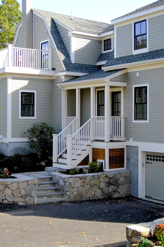 This is an example of a mid-sized traditional three-storey grey house exterior in Boston with wood siding, a gambrel roof and a shingle roof.