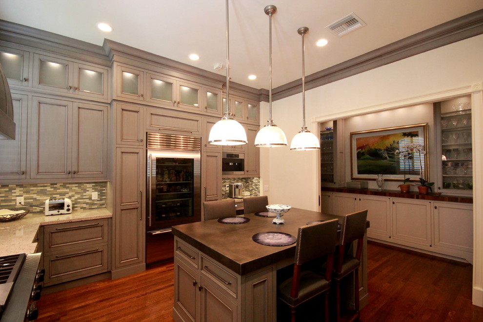 Enclosed kitchen - large transitional l-shaped dark wood floor and brown floor enclosed kitchen idea in Miami with a farmhouse sink, recessed-panel cabinets, gray cabinets, granite countertops, multicolored backsplash, mosaic tile backsplash, stainless steel appliances and an island