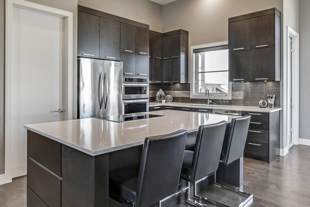 Design ideas for a contemporary kitchen in Calgary with an undermount sink, dark wood cabinets, grey splashback, stainless steel appliances and with island.