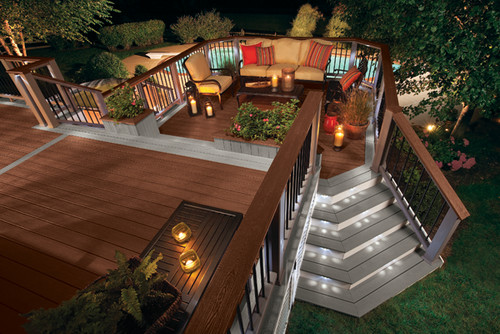 Depending on where your guests want to be, they can take one of the two sets of stairs coming off this deck. One set is diagonal and leads to the front yard, while the other leads directly down to the pool.