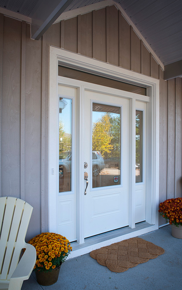 This is an example of a beach style entryway in Toronto with a single front door and a white front door.