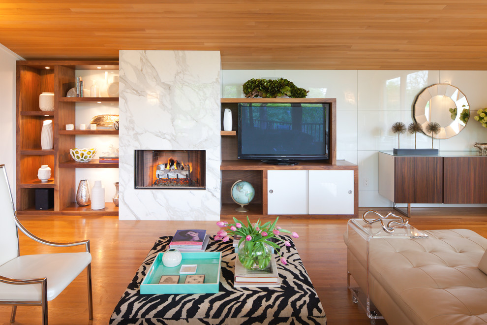 Photo of a midcentury living room in Portland with a standard fireplace, a stone fireplace surround and a freestanding tv.