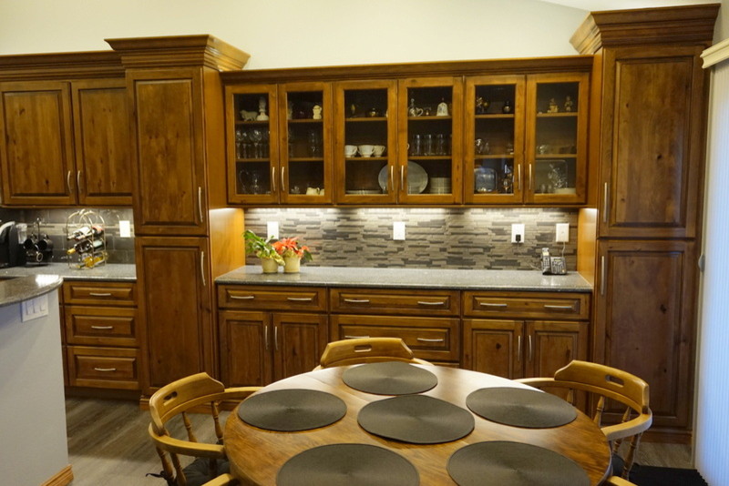 Inspiration for a large rustic gray floor eat-in kitchen remodel in Denver with an undermount sink, raised-panel cabinets, medium tone wood cabinets, quartz countertops, gray backsplash, metal backsplash and an island