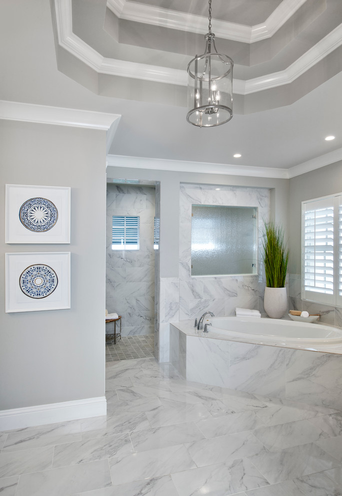Design ideas for a large tropical master bathroom in Miami with shaker cabinets, white cabinets, a drop-in tub, a curbless shower, grey walls, marble floors, an undermount sink, terrazzo benchtops, an open shower and white floor.