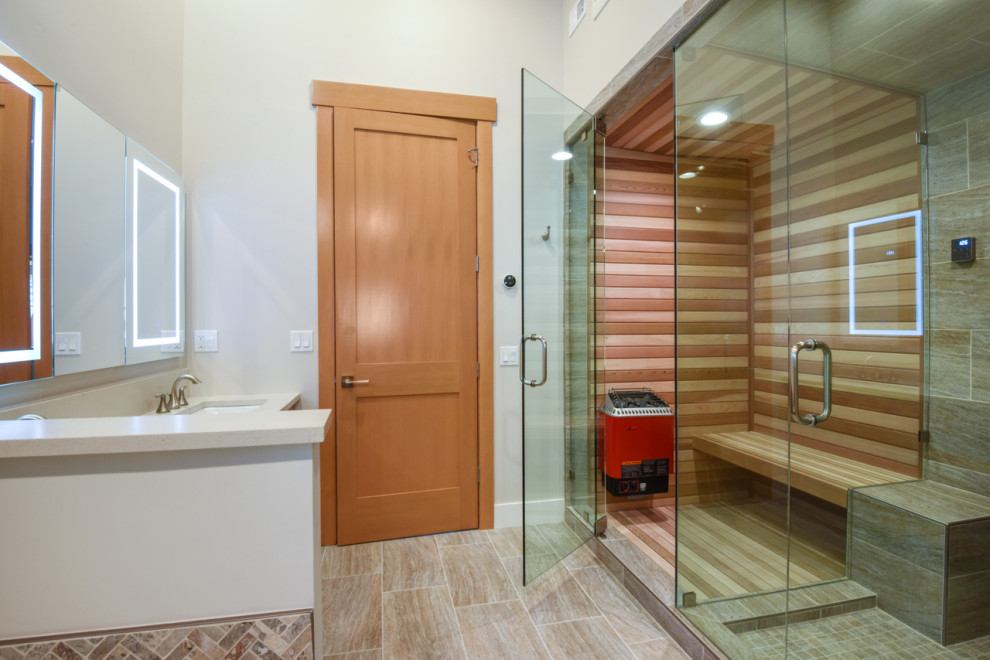 Photo of a large transitional wet room bathroom in Other with flat-panel cabinets, medium wood cabinets, an alcove tub, beige tile, ceramic tile, white walls, ceramic floors, with a sauna, beige floor, a hinged shower door, white benchtops, a double vanity, a built-in vanity and exposed beam.