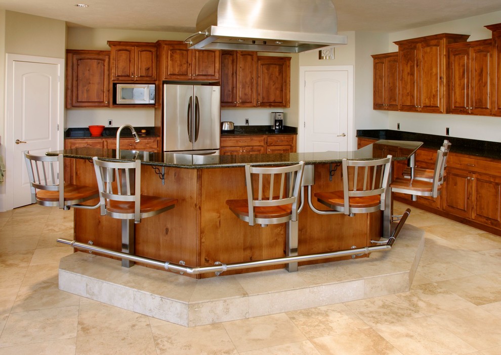 This is an example of a large traditional l-shaped eat-in kitchen in Salt Lake City with a drop-in sink, raised-panel cabinets, medium wood cabinets, beige splashback, stainless steel appliances, ceramic floors and with island.