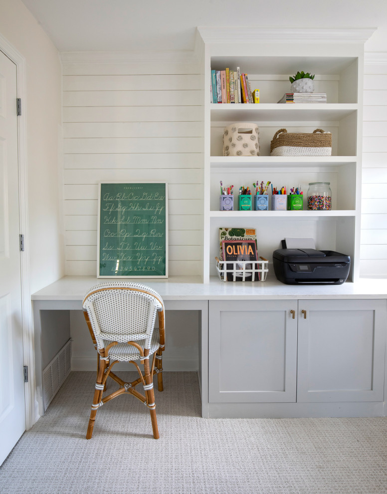 Photo of a mid-sized transitional craft room in Dallas with white walls, carpet, a built-in desk, grey floor and planked wall panelling.