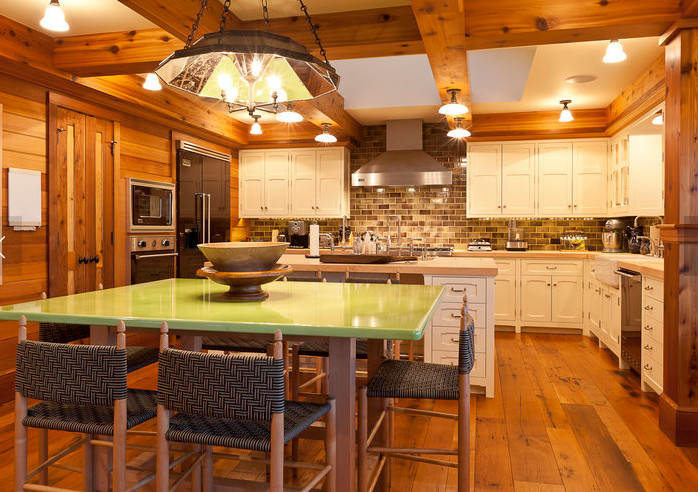 Eat-in kitchen - large rustic u-shaped medium tone wood floor and brown floor eat-in kitchen idea in Denver with an undermount sink, recessed-panel cabinets, white cabinets, wood countertops, brown backsplash, brick backsplash, stainless steel appliances and an island