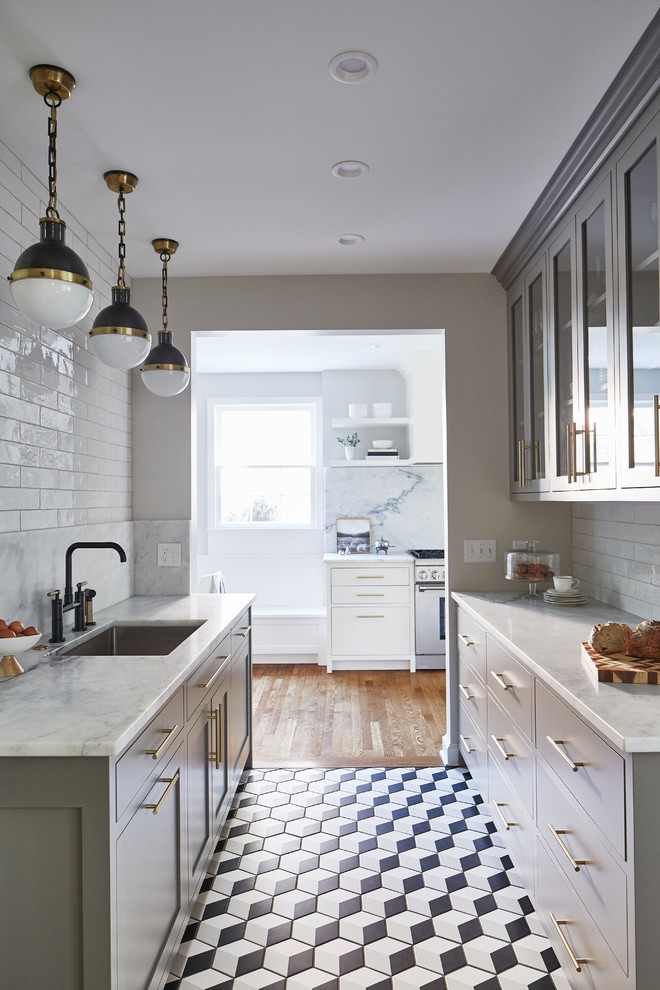 Mid-sized transitional galley kitchen pantry in Cleveland with an undermount sink, marble benchtops, white splashback, marble splashback, panelled appliances, white benchtop, recessed-panel cabinets, grey cabinets, multi-coloured floor and porcelain floors.
