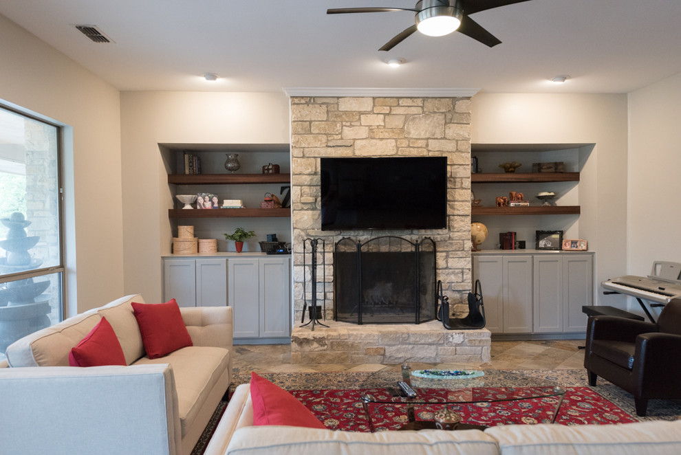 Large traditional enclosed family room in Austin with beige walls, ceramic floors, a standard fireplace, a stone fireplace surround, a wall-mounted tv and beige floor.