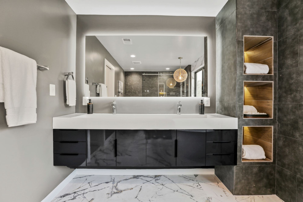 Inspiration for a large modern master bathroom in DC Metro with flat-panel cabinets, black cabinets, a freestanding tub, an alcove shower, a one-piece toilet, black and white tile, porcelain tile, multi-coloured walls, porcelain floors, a trough sink, white floor, a sliding shower screen, a niche, a double vanity and a floating vanity.
