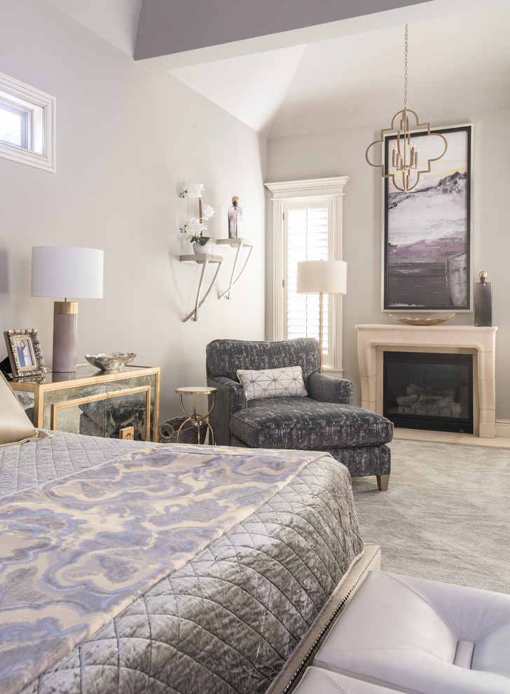 Design ideas for a mid-sized transitional master bedroom in Other with grey walls, carpet, a standard fireplace, a stone fireplace surround and grey floor.