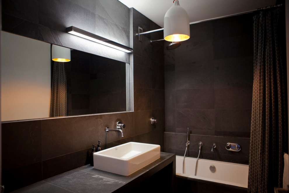 Medium sized contemporary ensuite bathroom in Paris with a submerged bath, black tiles, slate tiles, black walls, slate flooring, a built-in sink, black floors, black worktops and a single sink.