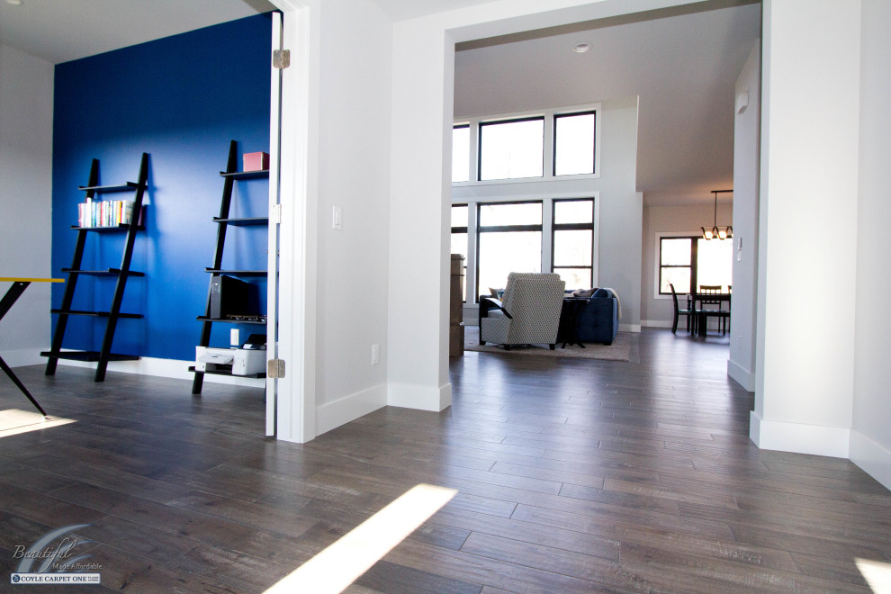Front door - mid-sized transitional medium tone wood floor and brown floor front door idea with white walls