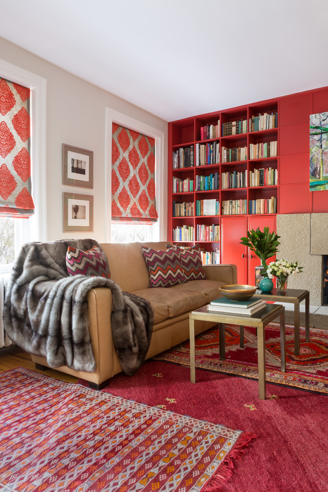 This is an example of a large eclectic open concept family room in DC Metro with a library, grey walls, carpet, a standard fireplace, a concrete fireplace surround and no tv.