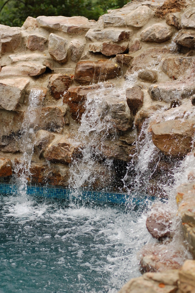 Example of a mid-sized transitional backyard brick and custom-shaped natural pool fountain design in Baltimore