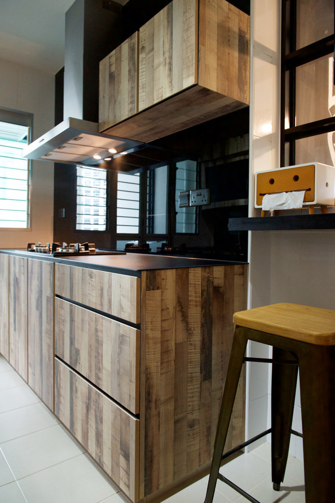 Design ideas for an industrial kitchen in Singapore with a double-bowl sink, medium wood cabinets, black splashback, porcelain splashback, coloured appliances and ceramic floors.