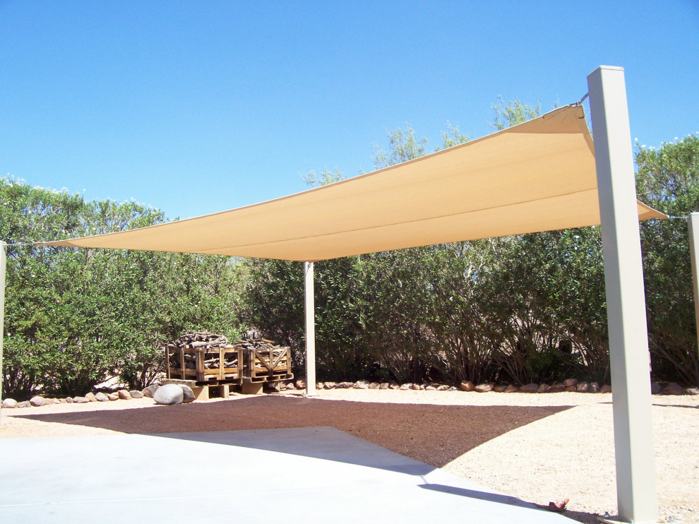 Large traditional backyard patio in Orlando with a fire feature and an awning.