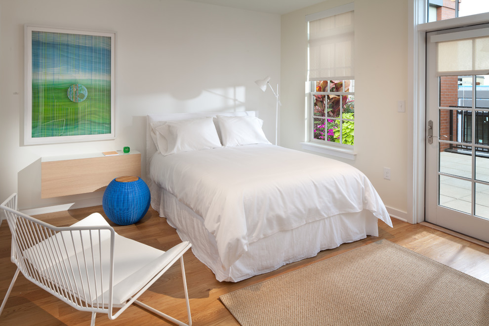 This is an example of a contemporary bedroom in DC Metro with white walls.