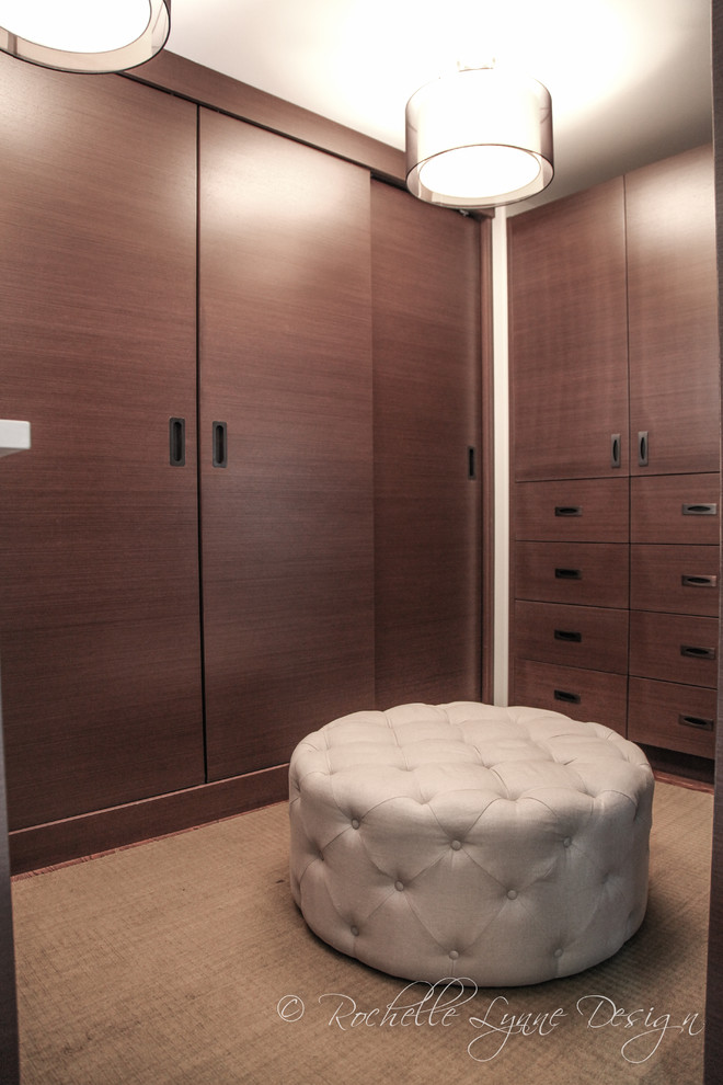 Inspiration for a small contemporary walk-in wardrobe in Calgary with flat-panel cabinets.