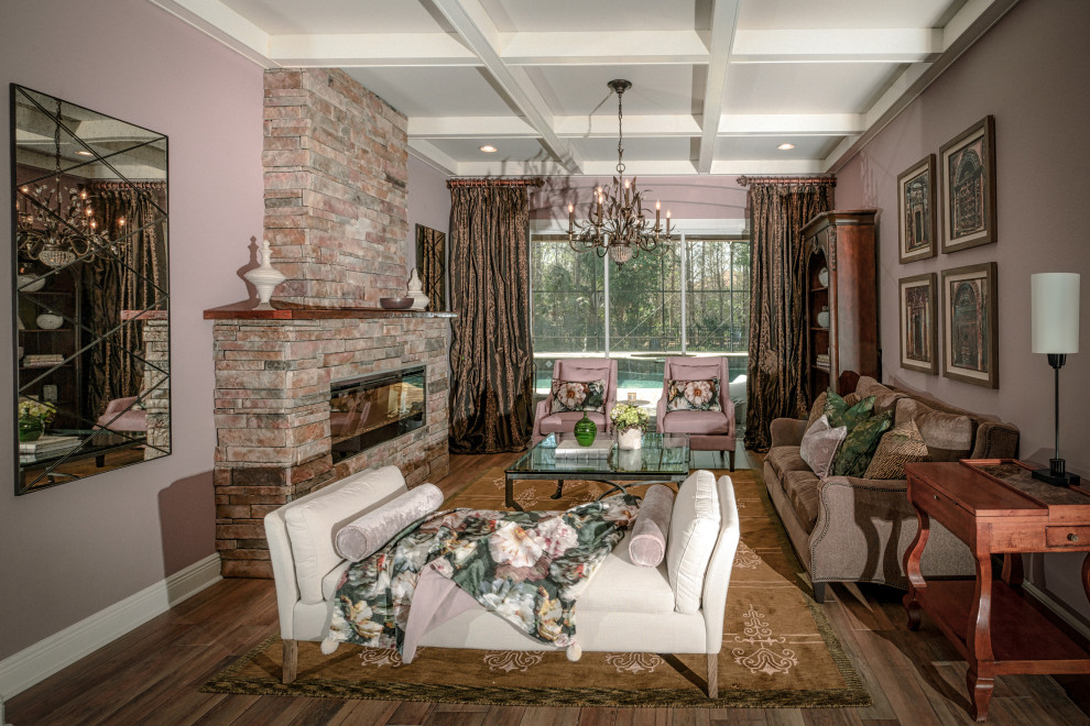 Inspiration for a large bohemian living room in Orlando with pink walls, porcelain flooring, a stacked stone fireplace surround, beige floors and a coffered ceiling.