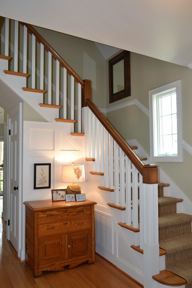 Traditional wood l-shaped staircase in Richmond with painted wood risers.