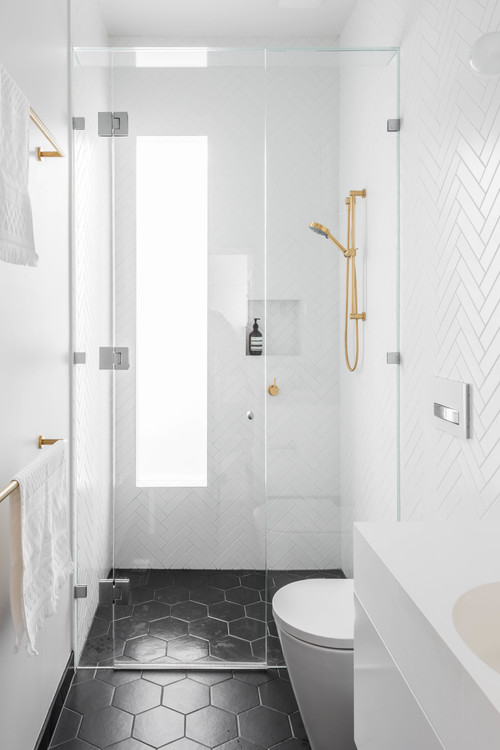 Small Space Luxury: White Bathroom with Gold Fixtures on a Black Background