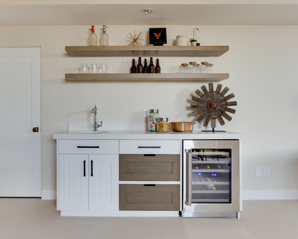 Inspiration for a country single-wall wet bar in Salt Lake City with an undermount sink, recessed-panel cabinets, white cabinets, beige splashback, carpet, beige floor and white benchtop.