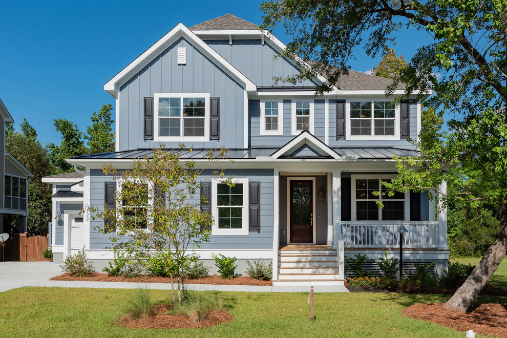 Transitional two-storey blue house exterior in Charleston with a gable roof.
