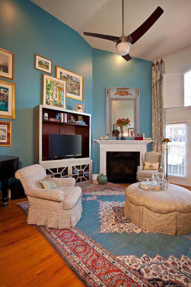Mid-sized transitional open concept living room in Raleigh with blue walls, medium hardwood floors, a corner fireplace and a wood fireplace surround.