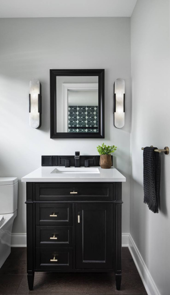 Inspiration for a transitional brown floor powder room remodel in Detroit with furniture-like cabinets, black cabinets, gray walls, an undermount sink, white countertops and a freestanding vanity