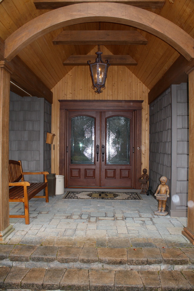 Inspiration for a mid-sized arts and crafts front door in New York with a double front door, a medium wood front door and multi-coloured floor.