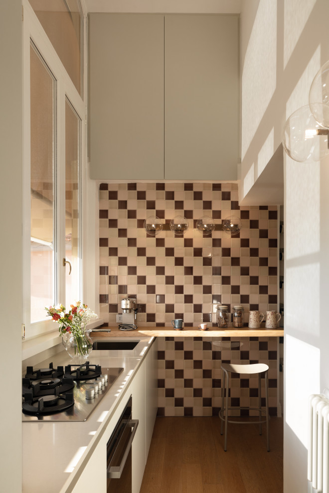 Example of a danish l-shaped open concept kitchen design in Rome with no island