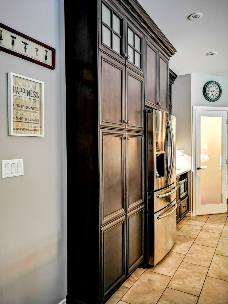 Mid-sized mountain style l-shaped medium tone wood floor and brown floor eat-in kitchen photo with a double-bowl sink, recessed-panel cabinets, dark wood cabinets, granite countertops, stainless steel appliances, an island and gray countertops